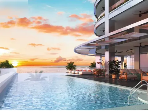 The developer's own rendering of the pool deck at sunset, sea view